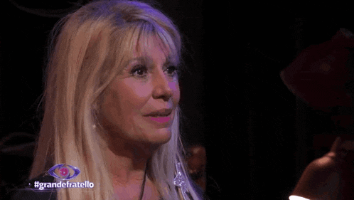 a close up of a woman 's face with the words grandefratello in the corner