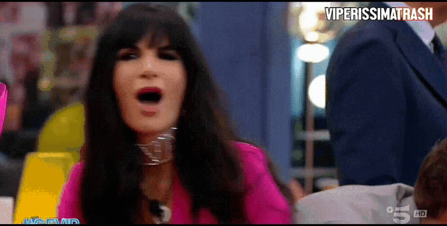 a woman in a pink shirt is screaming in a video that says viperissimotrash
