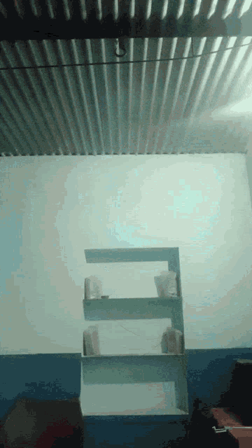 a room with a metal ceiling and a shelf