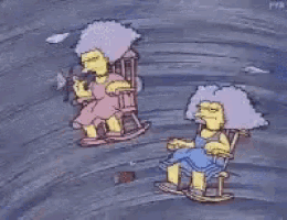 two cartoon characters are sitting in rocking chairs on a blue surface .