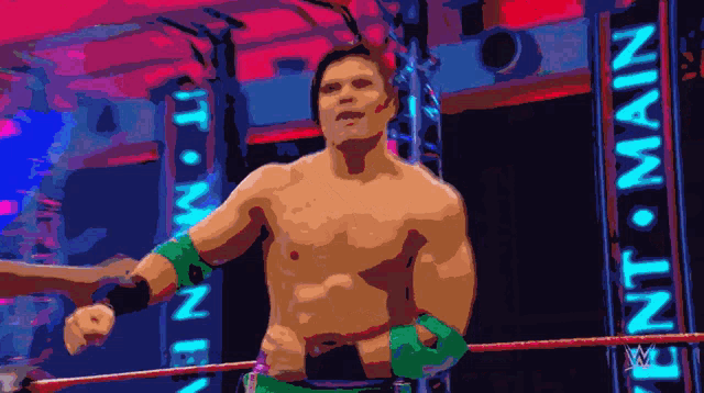 a man in a wrestling ring with a sign that says ent main