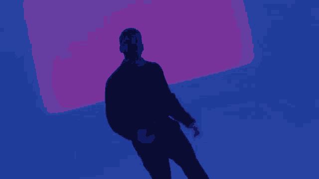 two men standing in front of a purple and blue square
