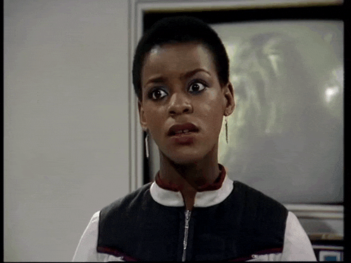 a close up of a woman 's face in front of a tv
