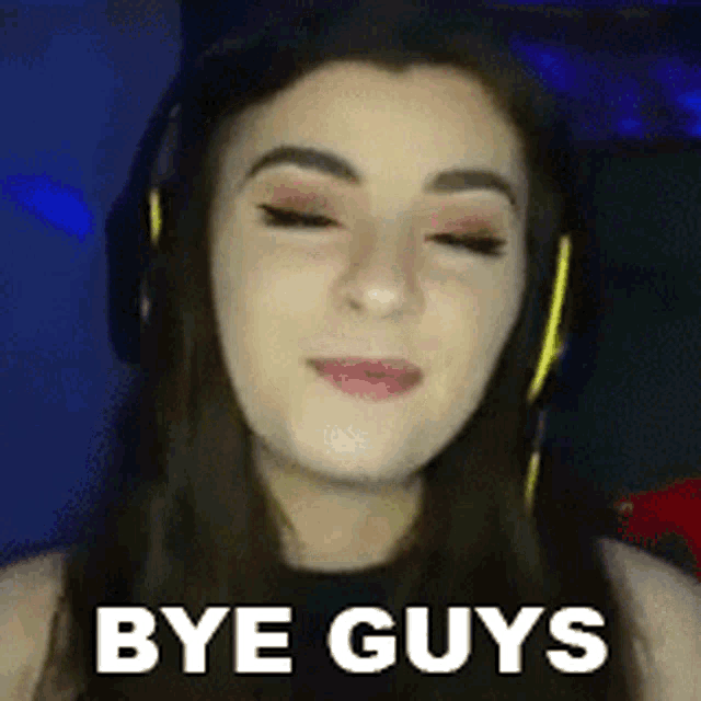 a woman wearing headphones says bye guys in front of her face .