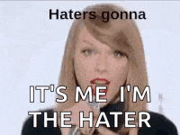 a woman is talking into a microphone with the words `` haters gonna it 's me i 'm the hater ''