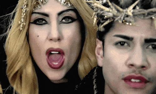 a woman with her tongue out next to a man with a starfish on his head