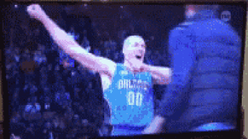 a basketball player from the dallas mavericks celebrates
