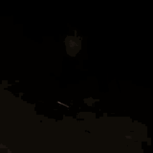 a naked man is standing in the dark with his eyes closed .