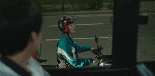 a person riding a motorcycle with a helmet on