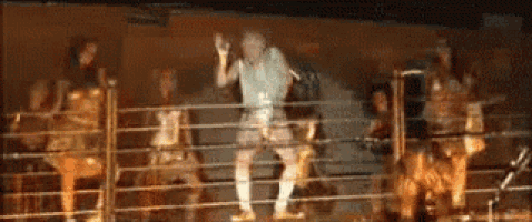 a blurred image of a group of people dancing in a ring .