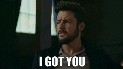 a man with a beard says " i got you " in front of a window
