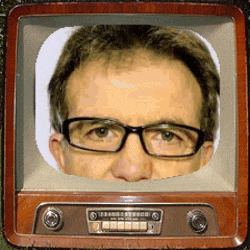 a man wearing glasses is looking out of a tv screen