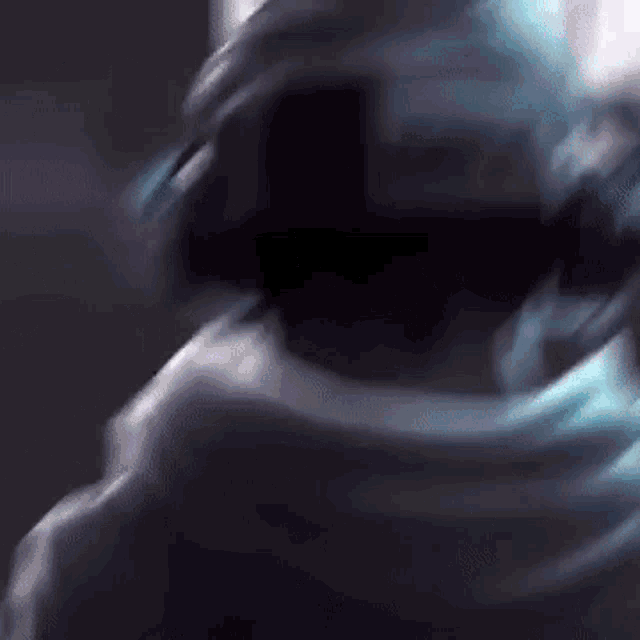 a close up of a person 's face in a dark room with a blurry background .
