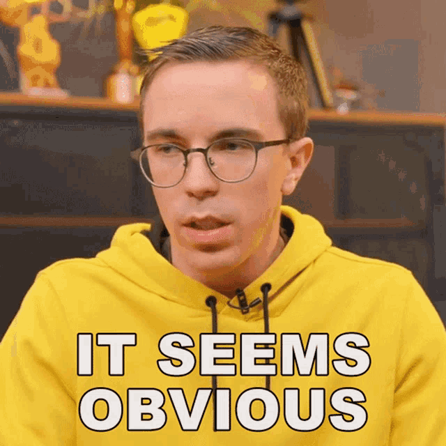 a young man wearing glasses and a yellow hoodie says it seems obvious