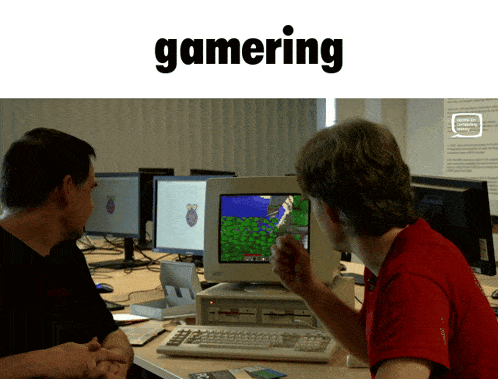 two men are playing a game on a computer and the word gaming is on the top
