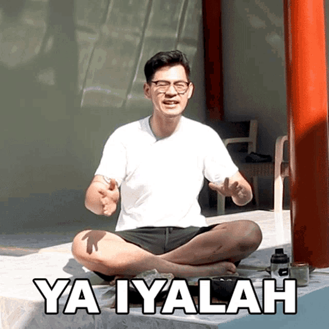 a man sits in a lotus position with the words ya iyalah written on the bottom