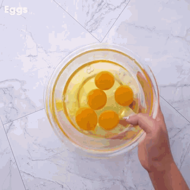 a person pouring cocoa powder into a bowl