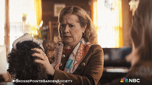 an advertisement for grosse pointe garden society has a woman holding a wig