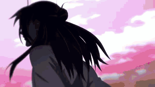 a silhouette of a person with long hair against a pink sky