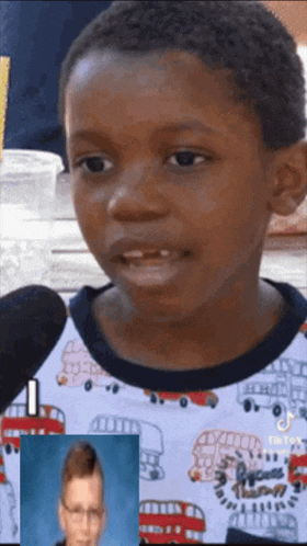 a young boy is talking into a microphone while wearing a shirt that says peace love