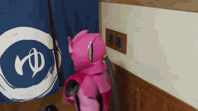 a person in a pink costume is standing in front of a blue and white sign that says yd