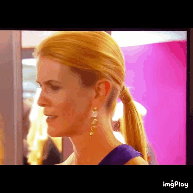a close up of a woman 's face with the words imgplay visible