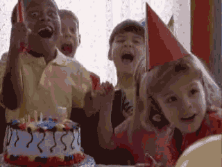 a group of children are celebrating a birthday with a cake that has the number 2250 on it