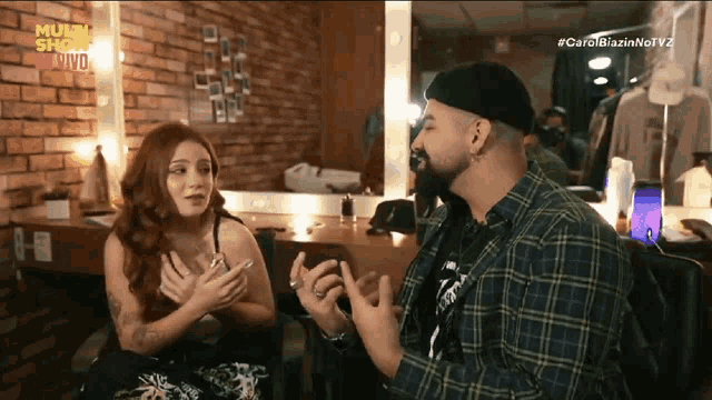 a man and a woman are having a conversation in front of a mirror with the words multi show on the bottom right