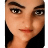 a close up of a woman 's face with her eyes closed and a serious look on her face .