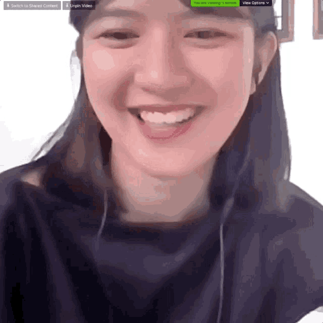 a woman is smiling in front of a screen that says view options