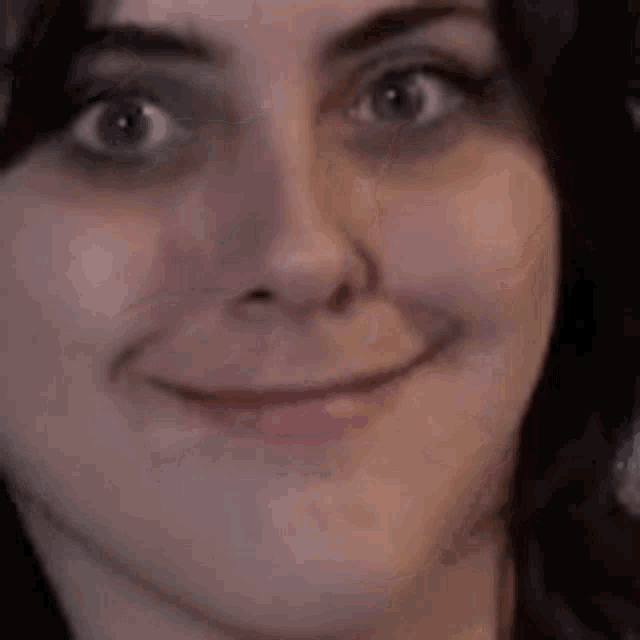 a close up of a woman making a funny face .