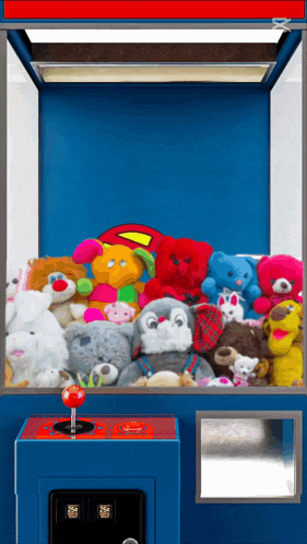 a claw machine filled with stuffed animals including a superman pillow