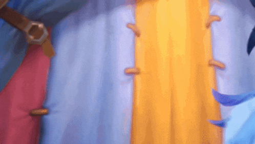 a blurry picture of a person standing in front of a wall with a blue , yellow , and red curtain .