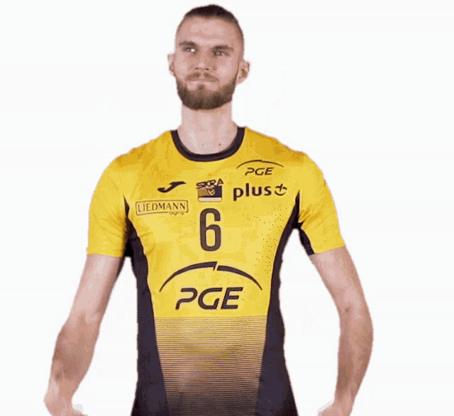 a man wearing a yellow and black shirt with the number 6 on it