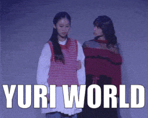 two girls are standing next to each other and the words yuri world are visible