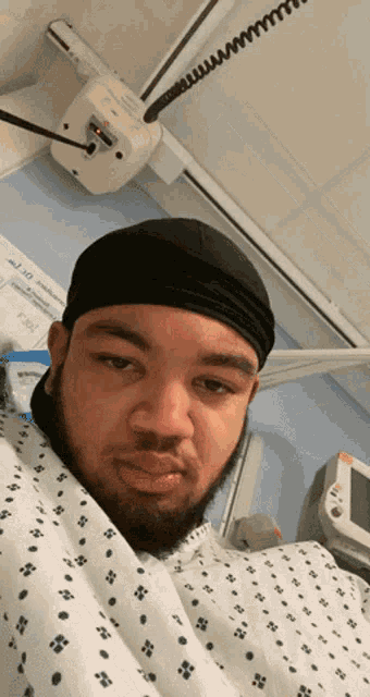 a man in a hospital gown has the number 10 on the wall