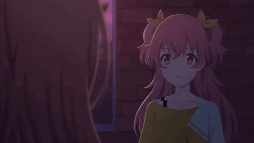 two anime girls are standing next to each other in front of a brick wall .