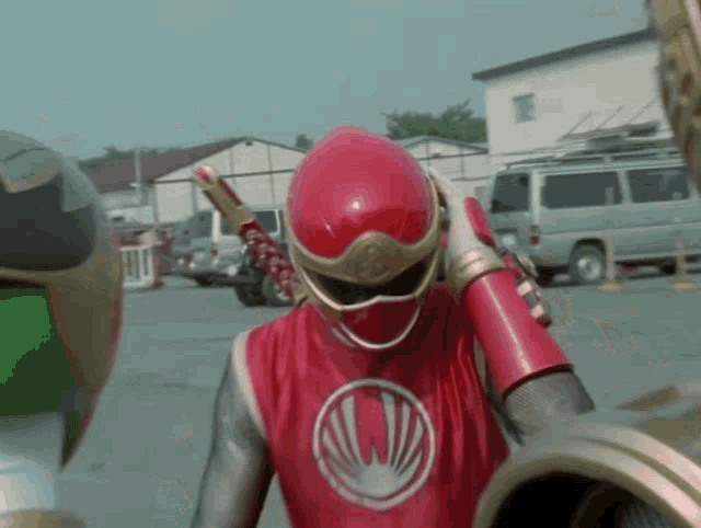 a man in a red helmet holds a sword