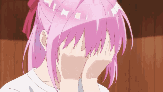 a girl with pink hair is covering her eyes with her hands