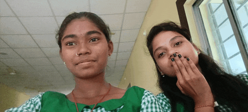 two girls are posing for a picture and one has a nose ring