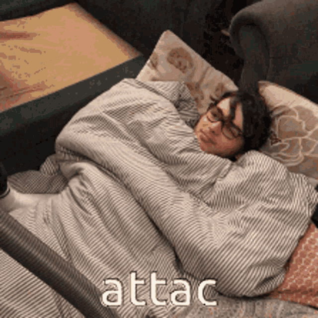 a person wrapped in a blanket with the word attac written on the bottom
