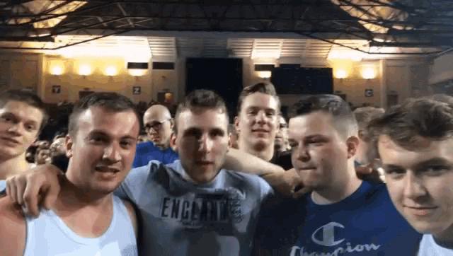 a group of young men are posing for a picture with one wearing a champion sweatshirt
