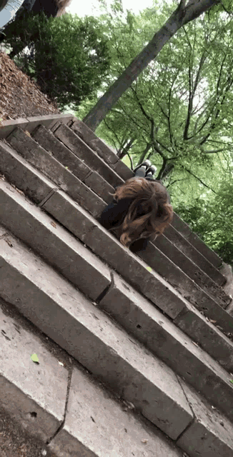 a person laying on a set of concrete stairs