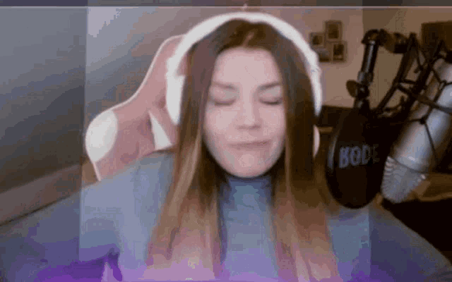 a woman wearing headphones and a rode microphone