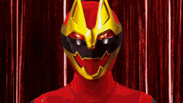a red superhero with a yellow mask on his face