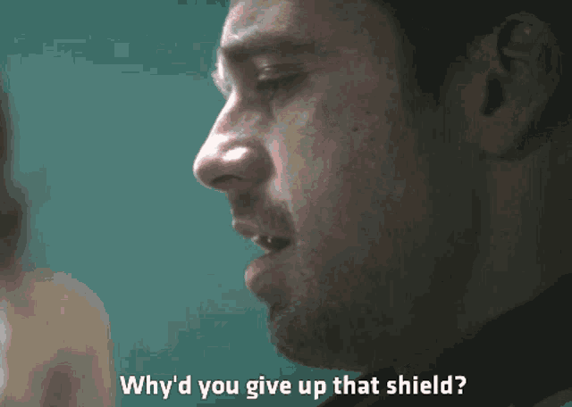a close up of a man 's face with the words why 'd you give up that shield below him
