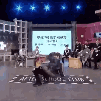 a group of people sitting in front of a screen that says make the mcs hearts flutter