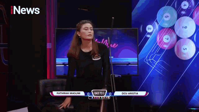 a woman stands in front of a screen that says race to 3