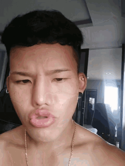 a man without a shirt is making a funny face with his mouth wide open