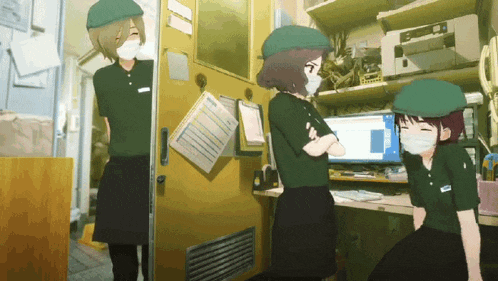 a woman wearing a mask stands in front of a computer screen